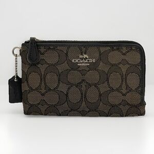 the Coach Corner Pouch wallet in Signature Canvas 64370 Brown Black